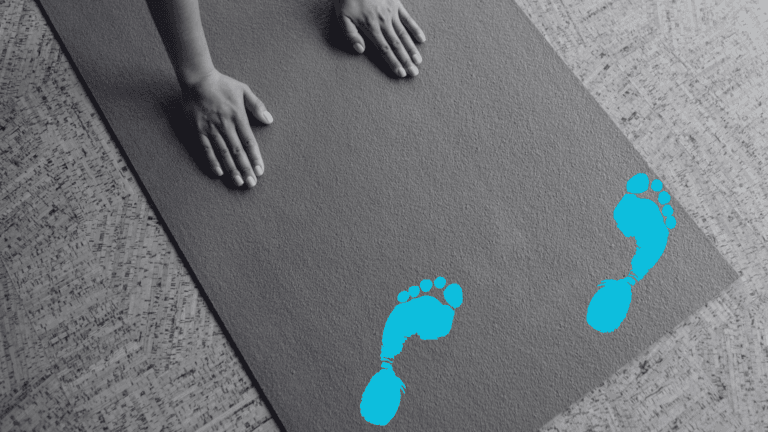 Woman practicing Down Dog on a yoga mat with illustrated footprints on it to denote someone walking across her mat