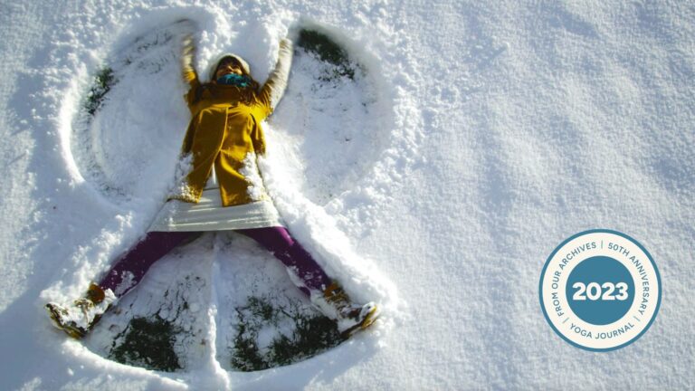 A woman making snow angels while fending off her holiday angst.