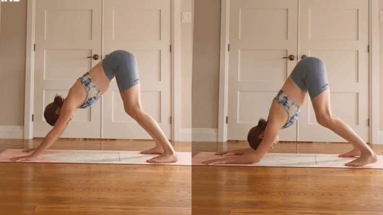 Yoga With Kassandra on a yoga mat at home practicing shoulder-strengthening exercises by shifting from Downward Dog into Dolphin Pose