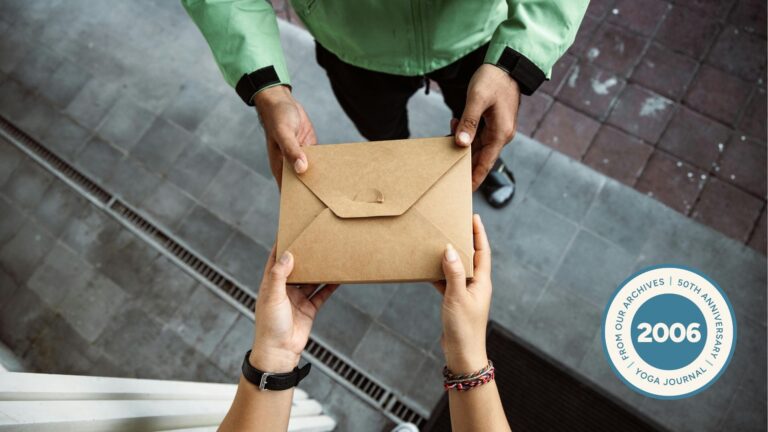 Close-up of two people exchanging cardboard box of food.