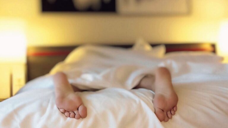 Image of person's feet in bed