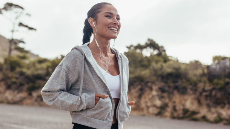 A woman in headphones using Yoga Journal's text to speech option