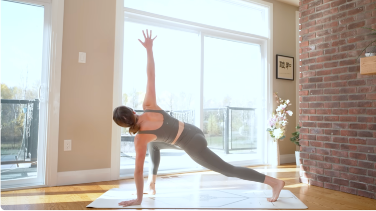Yoga teacher leading a power yoga for energy flow with a twisting low lunge