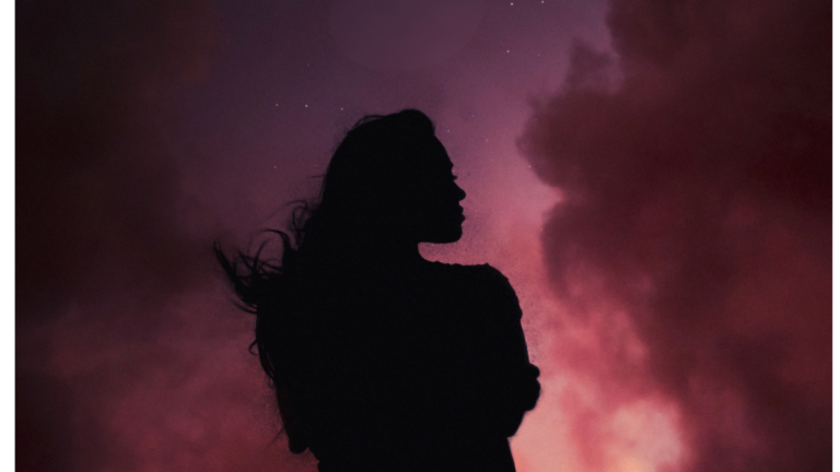Woman silhouette in front of the blood red color of the total lunar eclipse