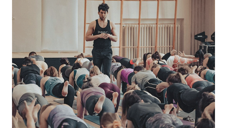 London-based yoga teacher Adam Husler teaches a class while walking and watching rather than demonstrating poses.