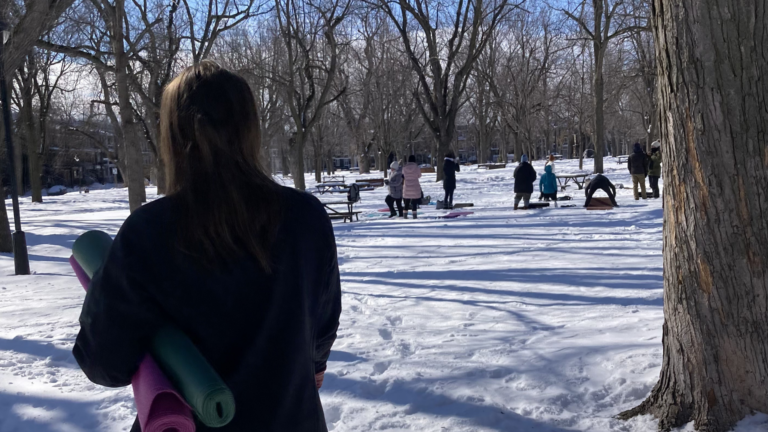 Woman standing in front of a snowga class in a park in Montreal